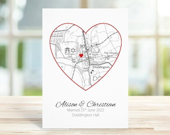 May include: A wedding announcement card with a black and white map of Doddington Hall, England, in the shape of a red heart. The map shows the location of the wedding ceremony, marked with a red heart. The text below the map reads "Alison & Christian Married 25th June 2022 Doddington Hall."
