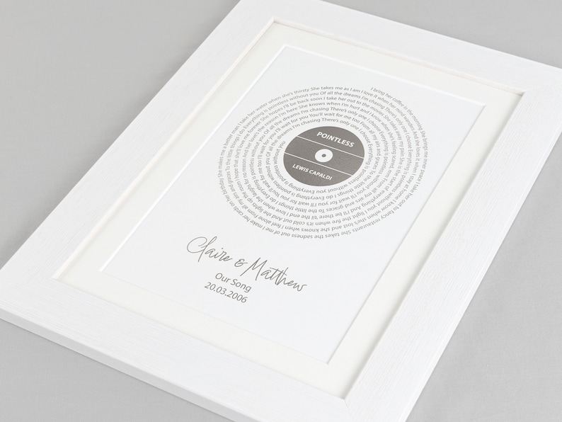 May include: A white framed print with a grey record design featuring the song "Pointless" by Lewis Capaldi. The print is personalised with the names "Claire & Matthew" and the date "20.03.2006".