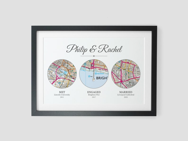May include: A framed print with three circular maps representing significant locations in a couple's relationship. The maps are labeled "Met", "Engaged", and "Married" with the corresponding locations and years. The text "Philip & Rachel" is at the top of the print.