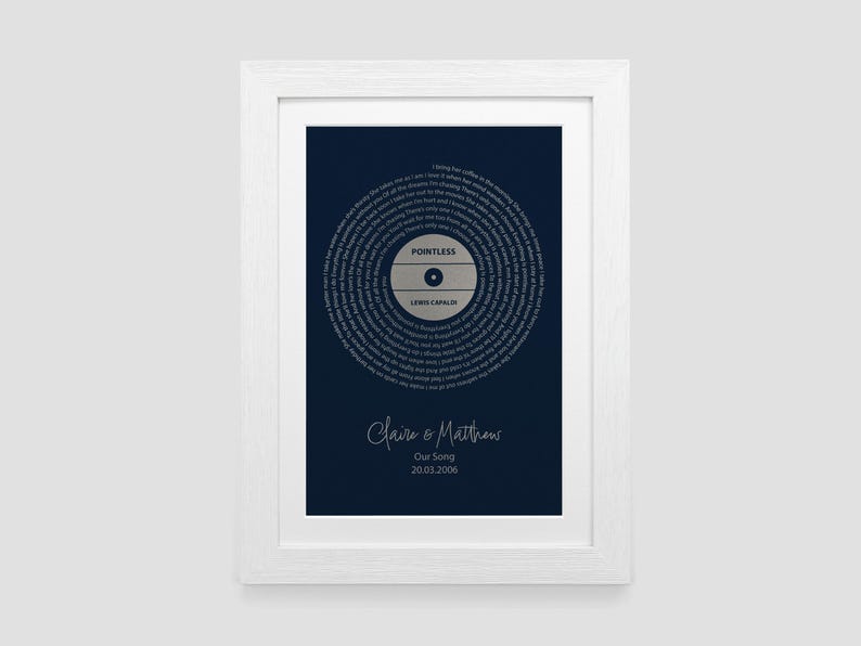 May include: A white framed print with a navy blue background featuring a stylized record with the song title "Pointless" by Lewis Capaldi. The text "Claire & Matthew Our Song 20.03.2006" is printed below the record.