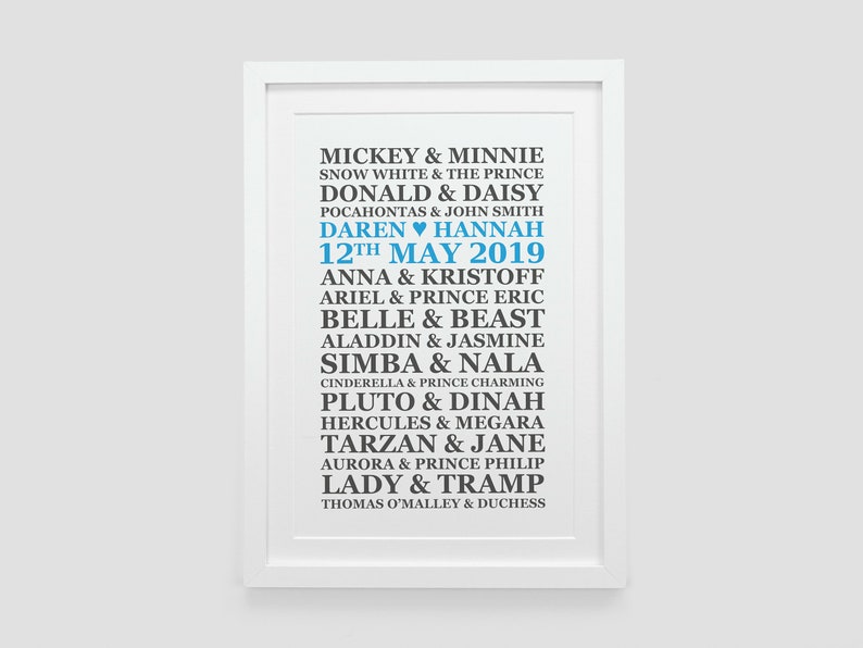 May include: A white framed print with a blue and black text design. The text lists Disney couples with their names, including Mickey & Minnie, Snow White & The Prince, Donald & Daisy, and more. The date "12th May 2019" is also included in the design.