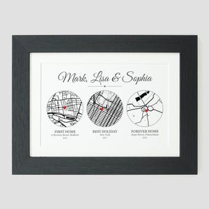 May include: A black and white map print with three circles showing different locations. The text reads "Mark, Lisa & Sophia" and includes the names of the locations and the years they were visited. The first circle is labeled "First Home" and shows a map of Belfast, the second circle is labeled "Best Holiday" and shows a map of New York, and the third circle is labeled "Forever Home" and shows a map of Fulham.