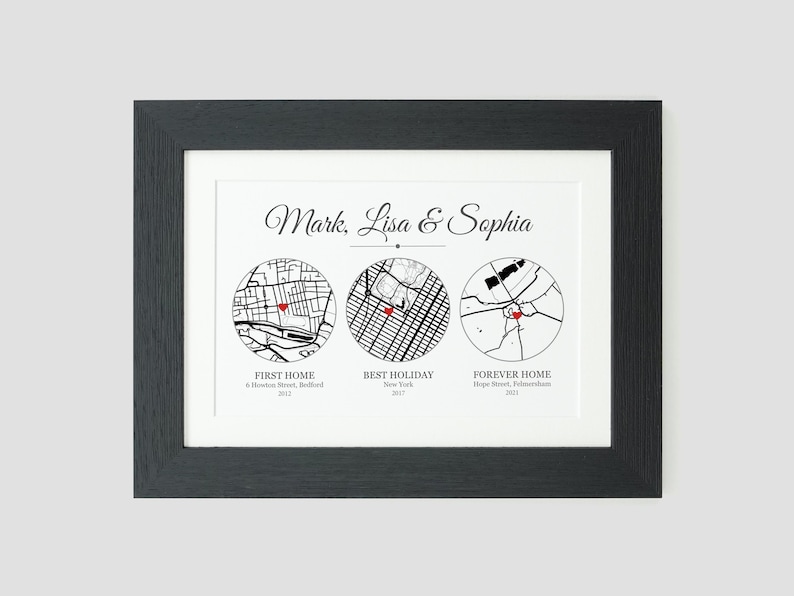 May include: A black and white map print with three circles showing different locations. The text reads "Mark, Lisa & Sophia" and includes the names of the locations and the years they were visited. The first circle is labeled "First Home" and shows a map of Belfast, the second circle is labeled "Best Holiday" and shows a map of New York, and the third circle is labeled "Forever Home" and shows a map of Fulham.