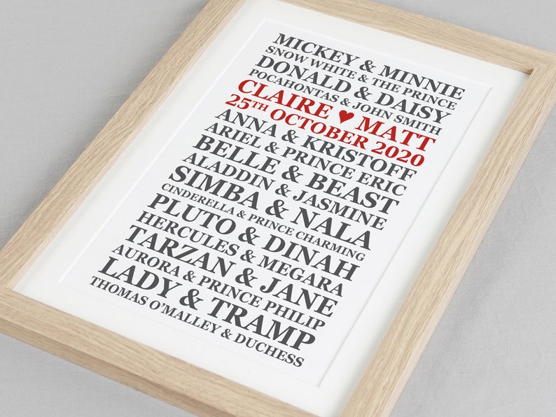 May include: A white framed print with black text listing Disney couples, including Mickey & Minnie, Snow White & The Prince, Donald & Daisy, and more. The text "CLAIRE MATT 25TH OCTOBER 2020" is in red.