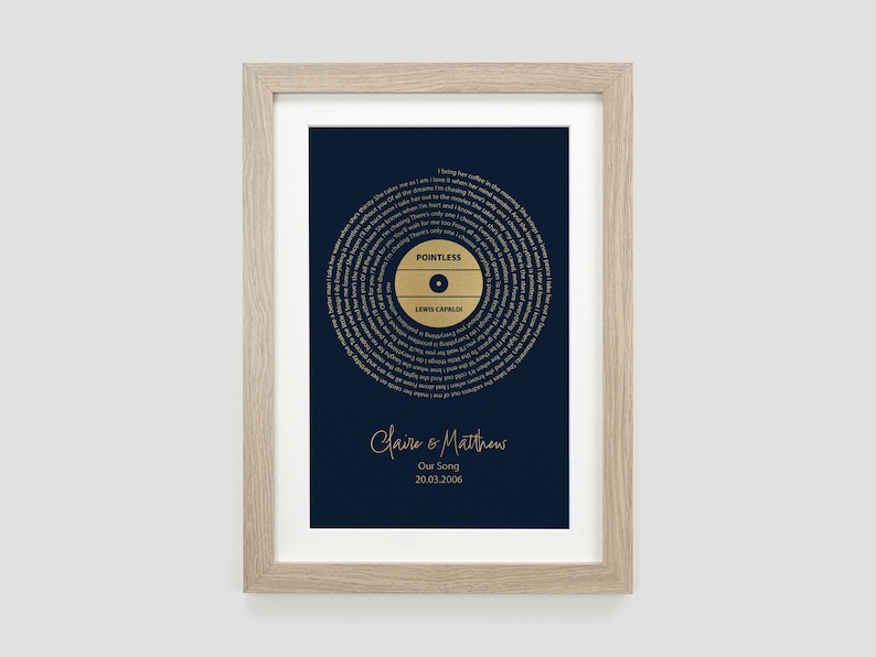 May include: A framed print of a gold record with the song title "Pointless" by Lewis Capaldi. The print is on a dark blue background and includes the names "Claire & Matthews" and the date "20.03.2008".