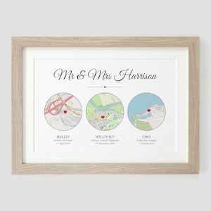 May include: A framed print with a white background and three maps. The maps are labeled "Hello", "Will You?" and "I Do!" with dates and locations. The text "Mr. & Mrs. Harrison" is at the top of the print.