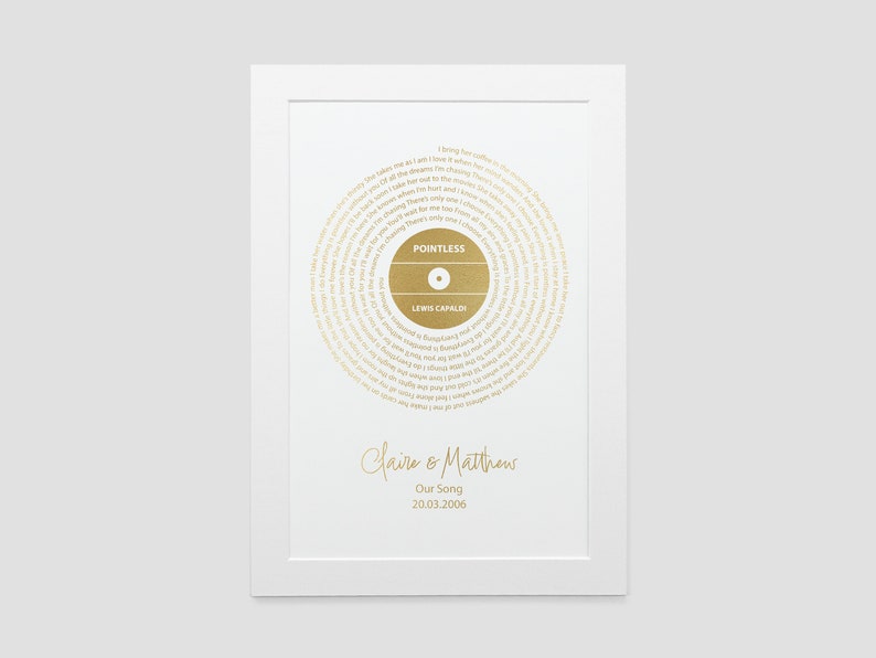 May include: A gold foil print of a record featuring the song "Pointless" by Lewis Capaldi. The print displays the lyrics of the song in a circular pattern around the record label. The print is personalised with the names "Claire & Matthew" and the date "20.01.2006".