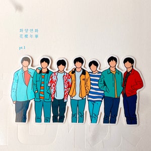 May include: A white album cover with the text "방탄소년단 The 3rd Mini Album  화양연화 花樣年華 pt.1" and a sticker of seven cartoon figures of men in different colored shirts and pants.