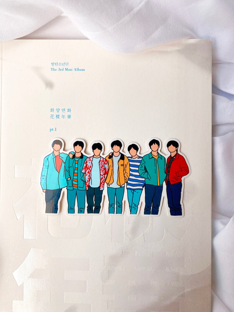 May include: A white album cover with the text "방탄소년단 The 3rd Mini Album  화양연화 花樣年華 pt.1" and a sticker of seven cartoon figures of men in different colored shirts and pants.