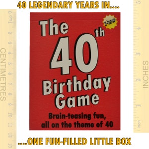 May include: A red box with the text "The 40th Birthday Game" in white and gray lettering. The box has a small yellow star with the word "NEW" on it. The text "Brain-teasing fun, all on the theme of 40" is printed in black below the game title.