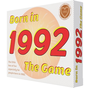 May include: A card game box with a red and yellow design. The box features the text "Born in 1992 The Game" and a smaller circle with the text "A New Card Game For People Born in 1992".