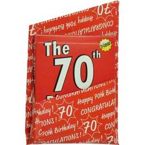 May include: Red and white birthday card with the text "The 70th" and a yellow star with the word "New". The card is folded in half and has a red and white pattern on the outside.