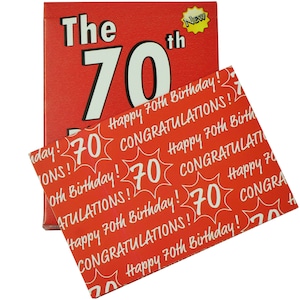 May include: A red card with the text "The 70th" in white. The card is decorated with a yellow star with the word "New" inside. The card is folded in half and a red card with a pattern of white "70"s and the text "Happy 70th Birthday!" and "Congratulations!" is visible underneath.