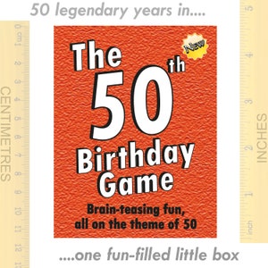 May include: A red box with the text "The 50th Birthday Game" in white. The box has a yellow star with the word "New" on it. The text "Brain-teasing fun, all on the theme of 50" is below the game title. The box is 5 inches tall.