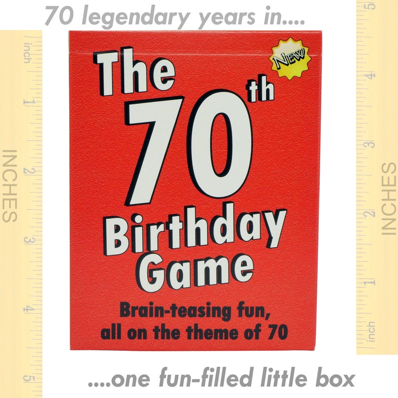 May include: A red box with the text "The 70th Birthday Game" in white and black lettering. The box has a yellow star with the word "NEW" on it. The text on the box reads "Brain-teasing fun, all on the theme of 70...one fun-filled little box."