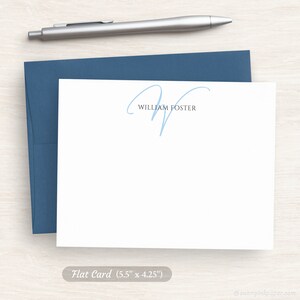 May include: A white flat card with a blue handwritten initial "W" and the text "William Foster" printed in black. The card measures 5.5 inches by 4.25 inches.