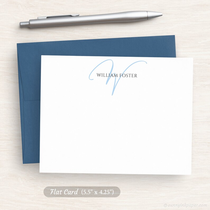 May include: A white flat card with a blue handwritten initial "W" and the text "William Foster" printed in black. The card measures 5.5 inches by 4.25 inches.