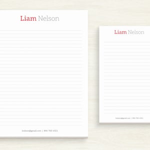 May include: Two white lined notepads with the name "Liam Nelson" printed in red at the top. The smaller notepad has contact information printed at the bottom.