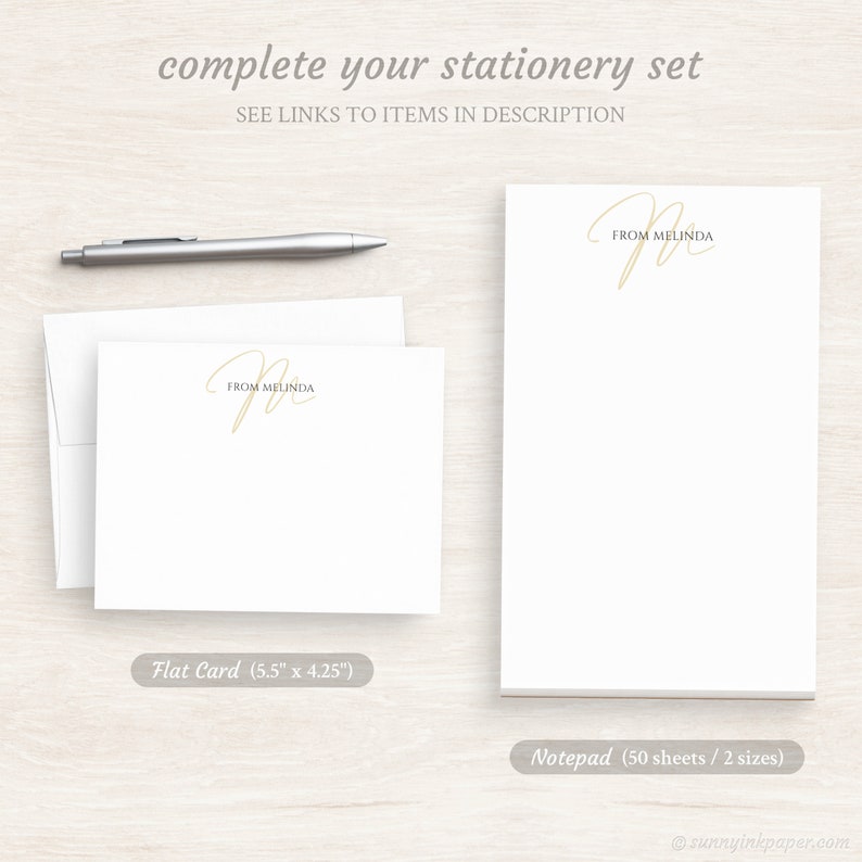 May include: A set of personalized stationery featuring a handwritten script monogram with the name "Melinda". The set includes a flat card measuring 5.5 inches by 4.25 inches and a notepad with 50 sheets in two sizes.