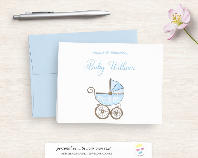 May include: A white card with blue and brown accents. The card says "From the nursery of Baby William" and features a blue baby carriage with lace details.