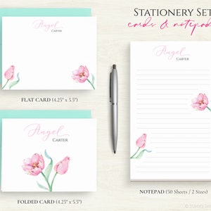 May include: A stationery set featuring a pink tulip design. The set includes a flat card, a folded card, and a notepad. The cards measure 10.8 cm by 14 cm. The notepad has 50 sheets and comes in two sizes. The text on the cards and notepad reads "Angel Carter".