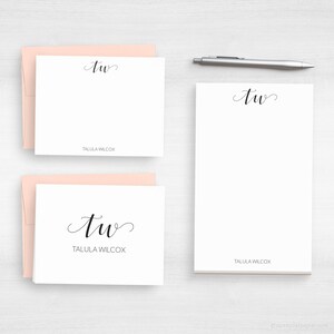 May include: Two white note cards with pink envelopes. The note cards feature the cursive initials "TW" and the name "Tallula Wilcox" printed below.