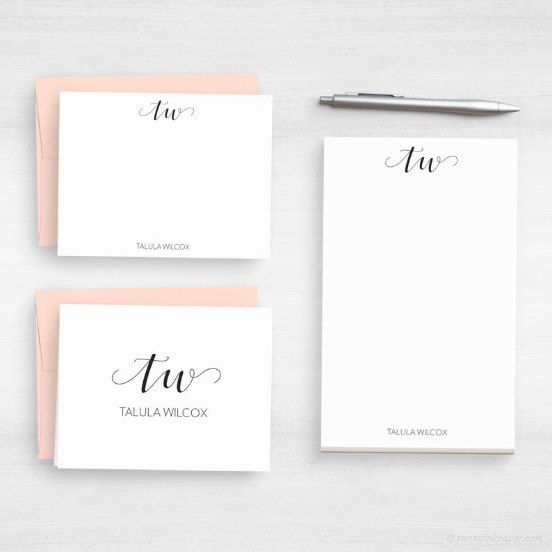 May include: Two white note cards with pink envelopes. The note cards feature the cursive initials "TW" and the name "Tallula Wilcox" printed below.