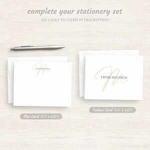 May include: Two white stationery cards with a gold script font that says "From Melinda". The card on the left is a flat card, and the card on the right is a folded card. Both cards are 5.5 inches by 4.25 inches.