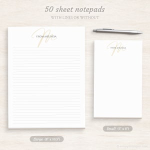 Op de afbeelding: Twee maten gepersonaliseerde notitieblokken met elk 50 vellen. Het grotere notitieblok is 8 inch bij 10,5 inch en het kleinere notitieblok is 5 inch bij 8 inch. Beide notitieblokken hebben een gouden cursief "M" met de tekst "From Melinda" erboven.