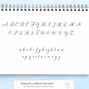 May include: A handwritten alphabet in cursive script, featuring both uppercase and lowercase letters. The letters are written in black ink on a white sheet of paper.