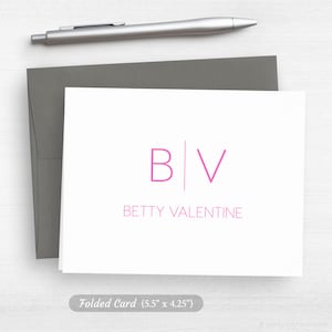 May include: A white folded card with a pink monogram of "B|V" and the text "BETTY VALENTINE" below. The card measures 5.5 inches by 4.25 inches.