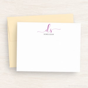 May include: White stationery card with a pink cursive monogram "ds" for Doris Shaw.