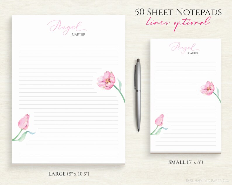 May include: Two lined notepad designs featuring pink tulip illustrations. The larger notepad measures 8 inches by 10.5 inches and the smaller notepad measures 5 inches by 8 inches. Both notepads have the text "Angel Carter" at the top. The text "50 Sheet Notepads lines optional" is at the top of the image.