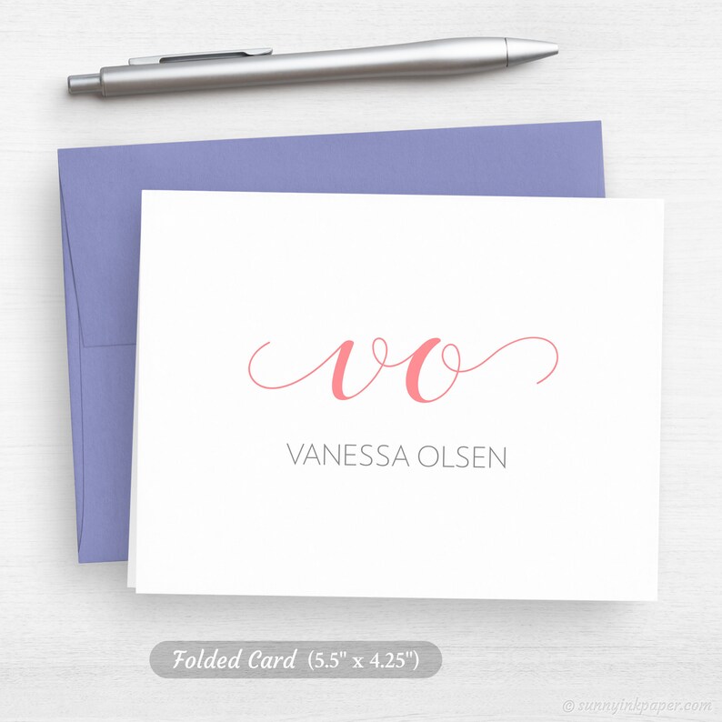 May include: A folded white card with a pink cursive "VO" monogram and the text "Vanessa Olsen" below. The card measures 5.5 inches by 4.25 inches.