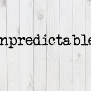 May include: The word "unpredictable" in a black, typewriter-style font is centered on a white, vertical wood-plank background. The wood grain is visible, and the planks are evenly spaced.