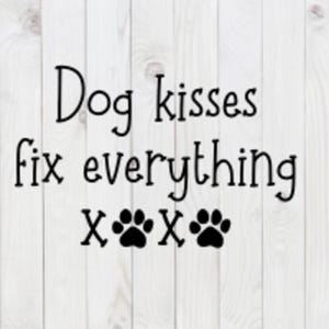 May include: Black and white text on a white wood background that reads "Dog kisses fix everything" with three paw prints below the text.