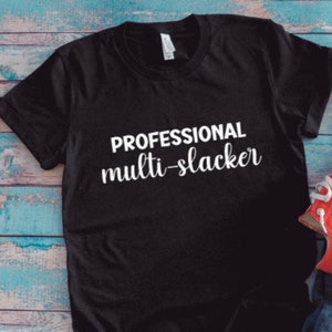 May include: Black t-shirt with white text that reads "PROFESSIONAL multi-slacker".