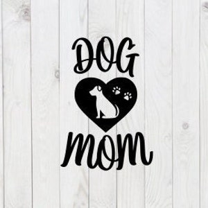 May include: Black and white graphic design with the text "DOG MOM" in a stylized font. A black heart with a white silhouette of a dog and three paw prints is centered between the words.