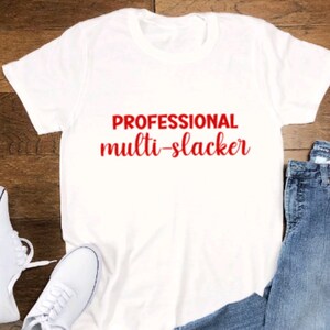 May include: White t-shirt with the text "PROFESSIONAL multi-slacker" in red lettering.