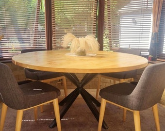 Bespoke round solid wood industrial style dining table, pedestal prism / spider base handmade in the UK. The Beswick.