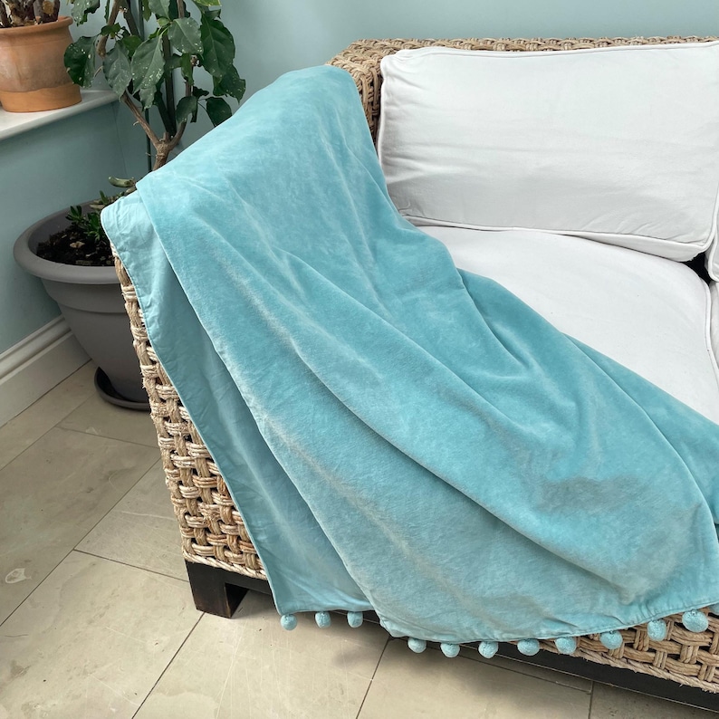 duck egg blue velvet pompom throw blanket