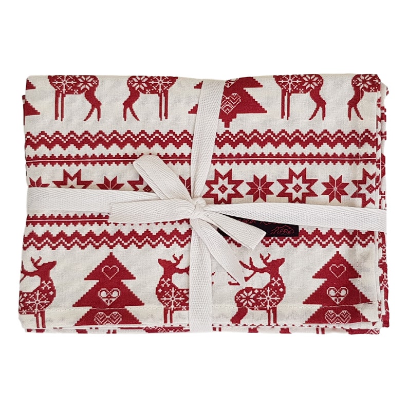 May include: A set of folded Christmas-themed fabric napkins tied with a white ribbon. The napkins feature a repeating pattern of red reindeer, trees, and geometric designs on a cream background. The overall theme is festive.