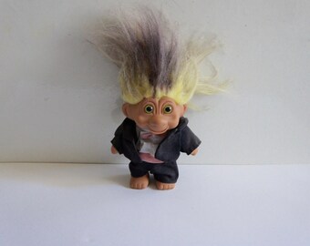 black troll doll with blonde hair
