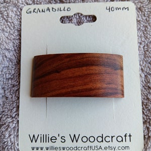 May include: A 40mm Granadillo wood knob with a curved shape and a wood grain pattern. The knob is packaged on a white card with the text "Willie's Woodcraft" and "www.willieswoodcraftUSA.etsy.com".