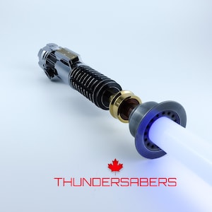 May include: A detailed lightsaber with a silver, black, and gold hilt and a white blade emitting a blue glow. The text "THUNDERSABERS" is displayed in red below the lightsaber, along with a red maple leaf.