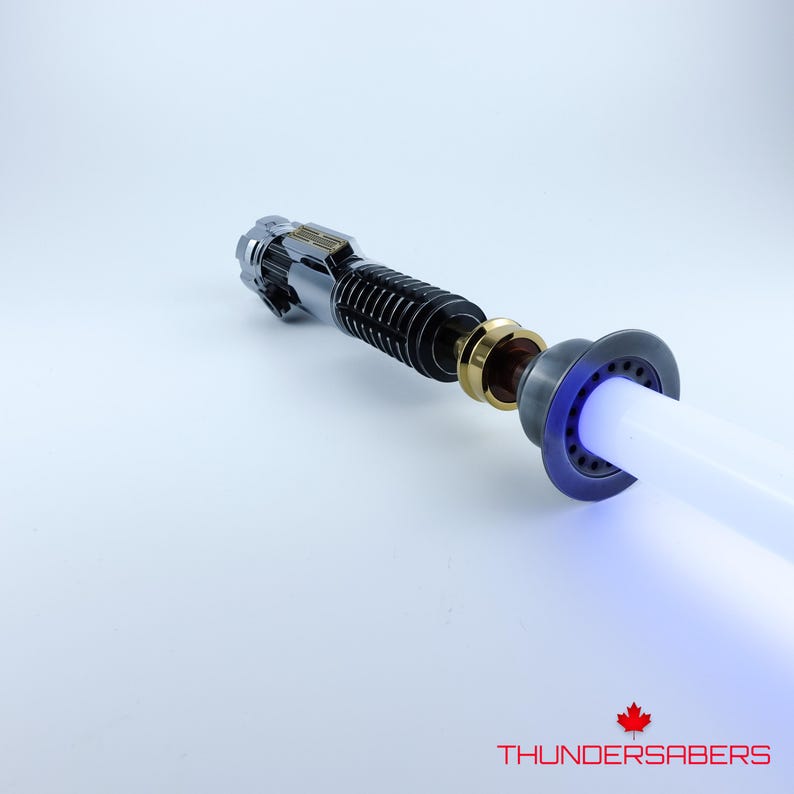 May include: A lightsaber with a silver and black hilt, gold detailing, and a bright white and blue blade. The text "THUNDERSABERS" is visible at the bottom of the image.