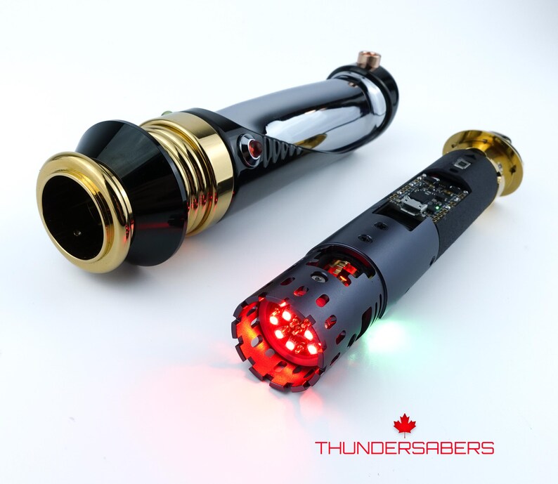 Puede incluir: Dos sables de luz futuristas. Uno es negro, dorado y cromado, con luz roja. El otro es negro con luz roja y una placa de circuito visible. El texto "THUNDERSABERS" est&aacute; en la parte inferior.