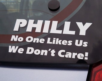 May include: A white sticker on the back of a car that reads "PHILLY No One Likes Us We Don't Care!"