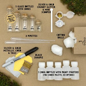May include: A craft kit with glass bottles, corks, pipettes, glitter, cotton balls, metallic cord, tags, and a black Sharpie. Includes five 20ml bottles with paint starters. The kit also includes a bonus extra bottle.