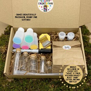May include: An open cardboard box filled with potion-making supplies. The kit includes small glass bottles with corks, plastic bottles with colorful lids, a marker, and a brown paper bag. Text on the box reads "Crafty Countdown" and "Comes beautifully packaged, ready for gifting!"